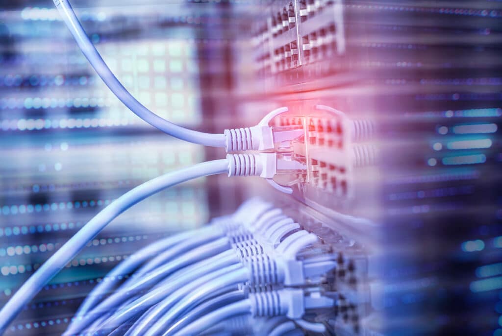 Network cables connecting to a network swtich, representing the FCC’s STIR/SHAKEN framework for robocall prevention.