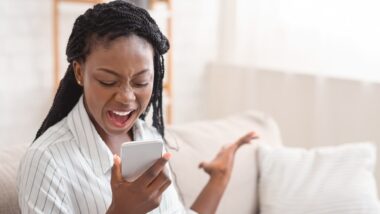 Woman upset at another robocall yelling at her phone, Real estate robocalls and spam texts offering to buy and sell homes may be illegal without consumer consent.