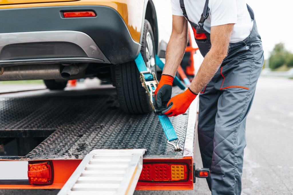 Close up of a car being towed, representing the Freedom Credit Union repossession settlement.