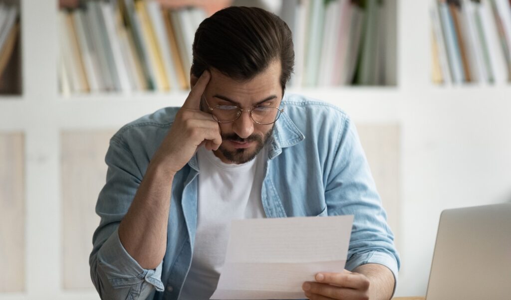 Man reading Data breach notification, Data breach letters inform consumers when and how their information was compromised by data breach incidents.