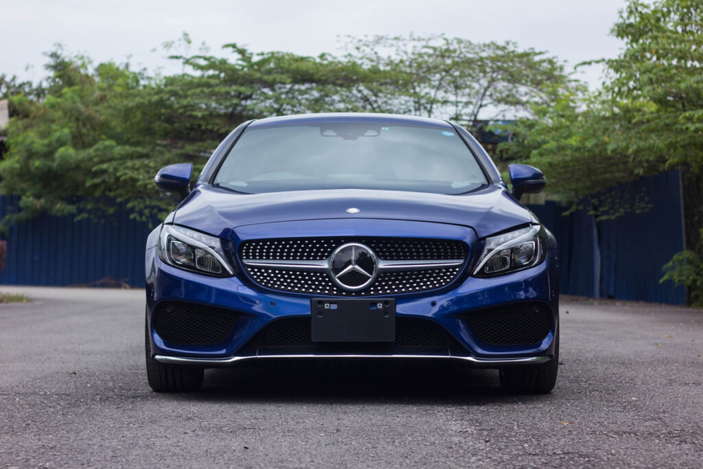 Front view of a blue Mercedes C300, representing the Mercedes-Benz recall.