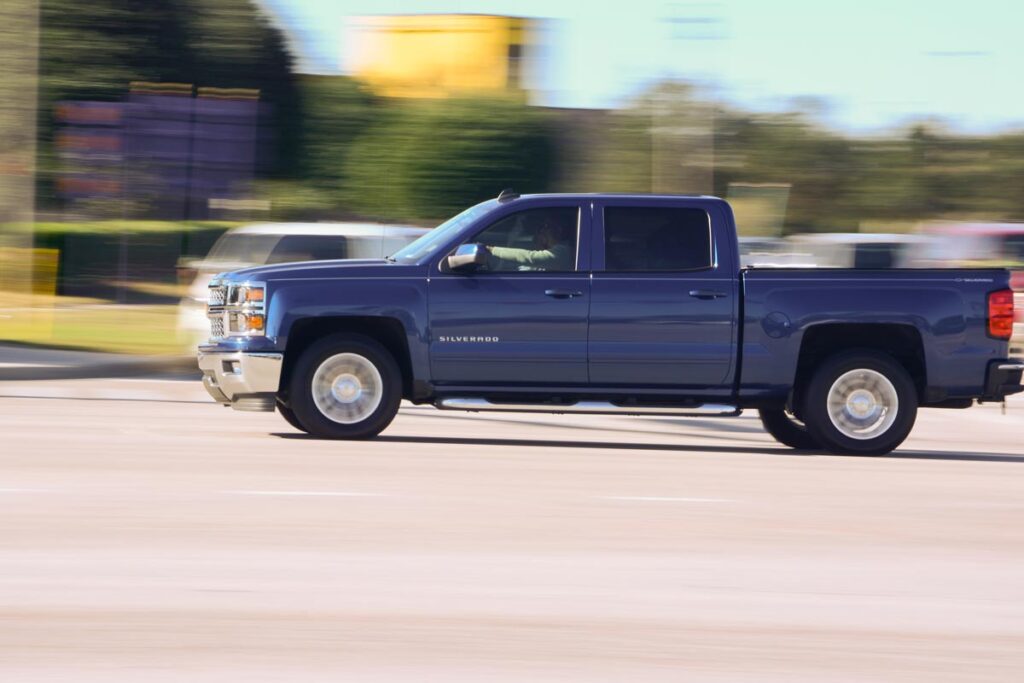 A Silverado driving down a road, epresenting the GM and Robert Bosch lawsuit.