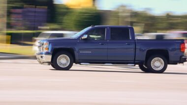 A Silverado driving down a road, epresenting the GM and Robert Bosch lawsuit.