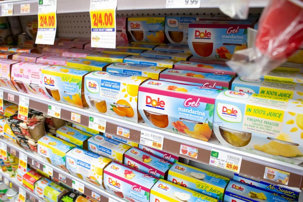 Dole fruit cups on a grocery store shelf, representing the Dole class action lawsuit settlement.