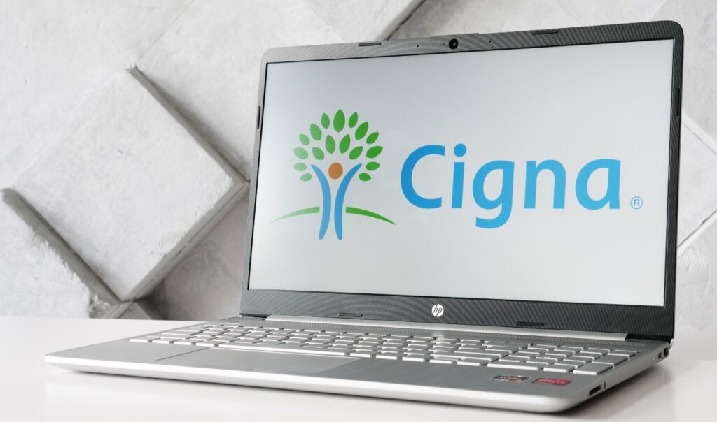 Cigna Corporation logo of health insurance company on the screen in front of webpage