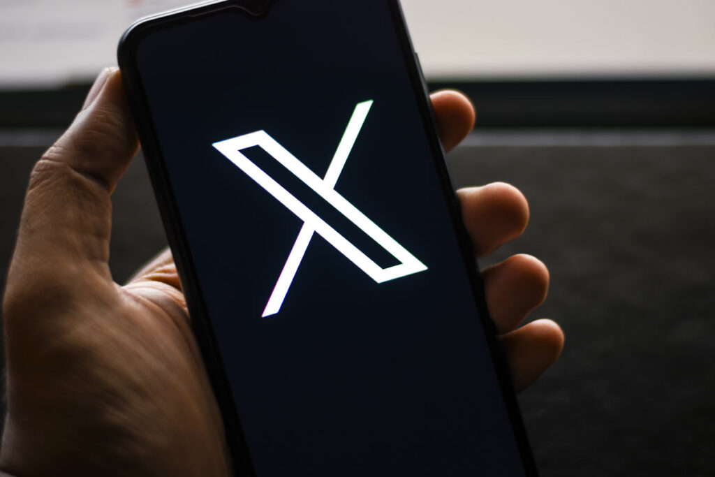 X Corp logo seen on a smartphone screen,