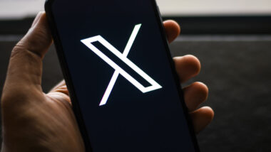 X Corp logo seen on a smartphone screen, representing the X Corp. data scraping lawsuit.