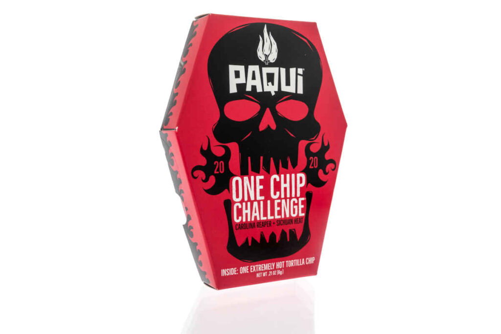 A package of Paqui with carolina reaper peppers sichuan heat one extremely hot tortilla chip representing the Paqui 'One Chip Challenge' product removal.