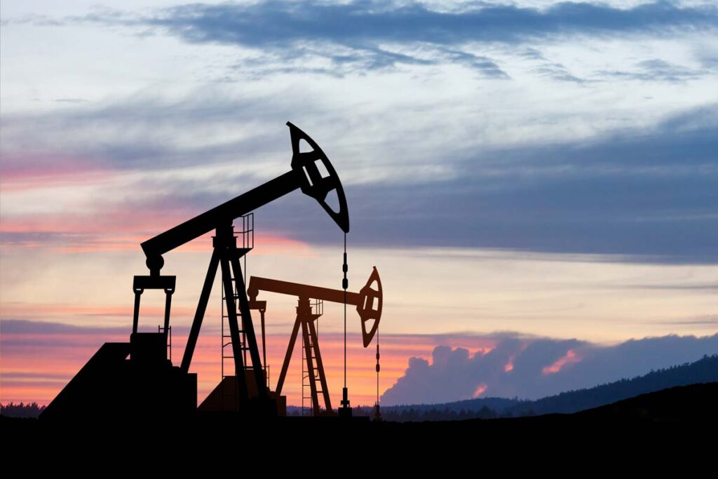 Oil drillers against a sunset sky, representing the California fossil fuels lawsuit.