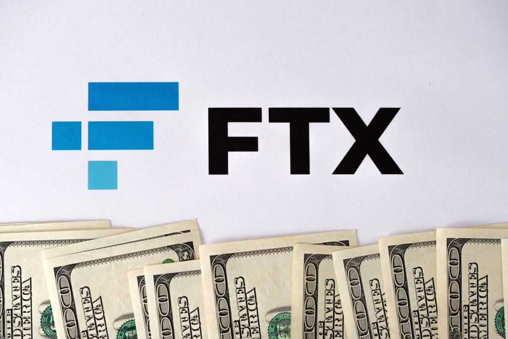 FTX logo with money displayed in front, representing the Bankman-Fried lawsuit.