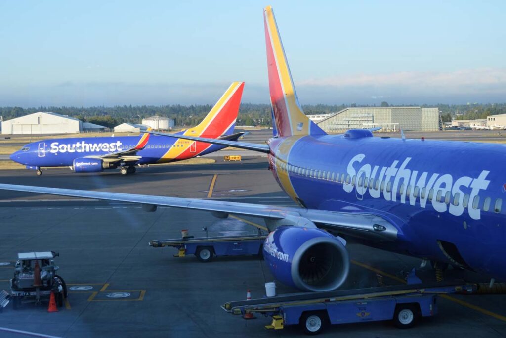 Southwest planes at an airport terminal, representing the Southwest COVID-19 cancellations class action lawsuit.