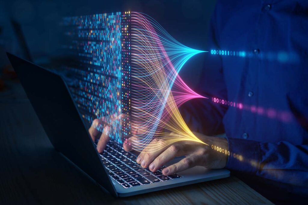 Close up of a person using a laptop with a data concept overlay, representing the CareCentrix and AMCA data breach class action lawsuit settlement.