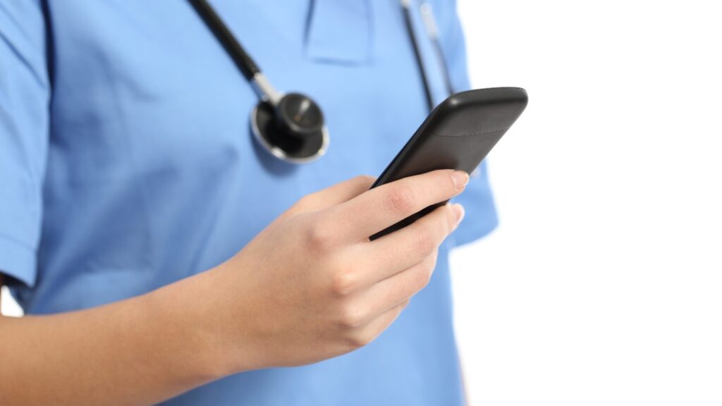 Close up of a nurse hand using a smart phone isolated on a white background, representing the Med-Call Healthcare class action lawsuit settlement.