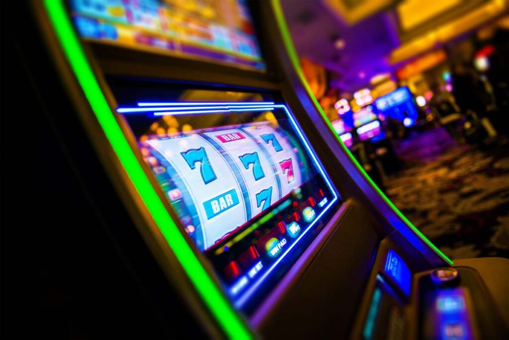 Close up of a casino slot machine, representing the Caesars cyberattack.