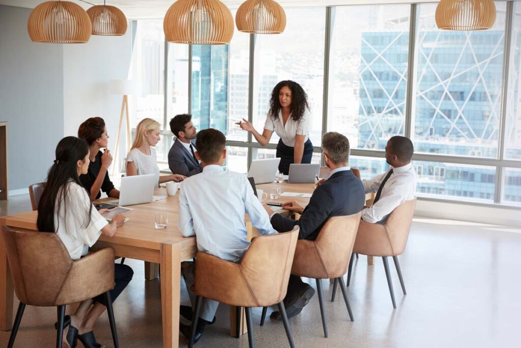 A businesswoman leading a meeting, representing the gender pay gap.