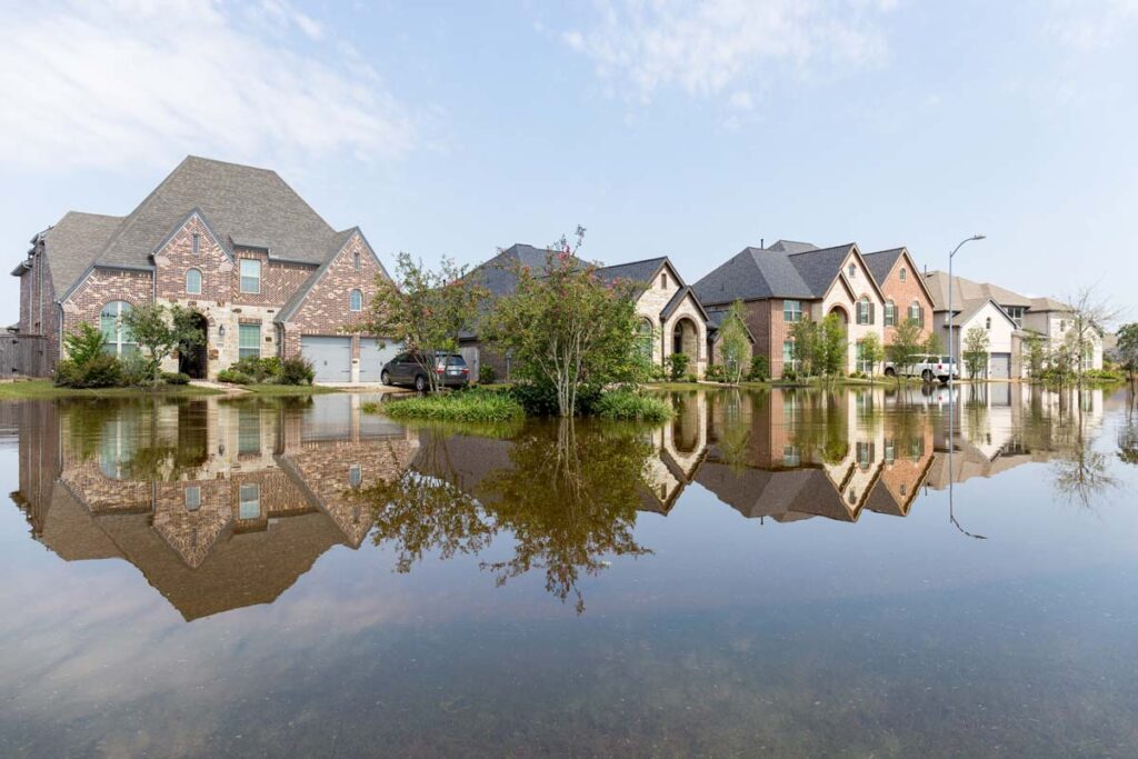 Flooded suburban neighborhood, representing the home climate risks Zillow study.