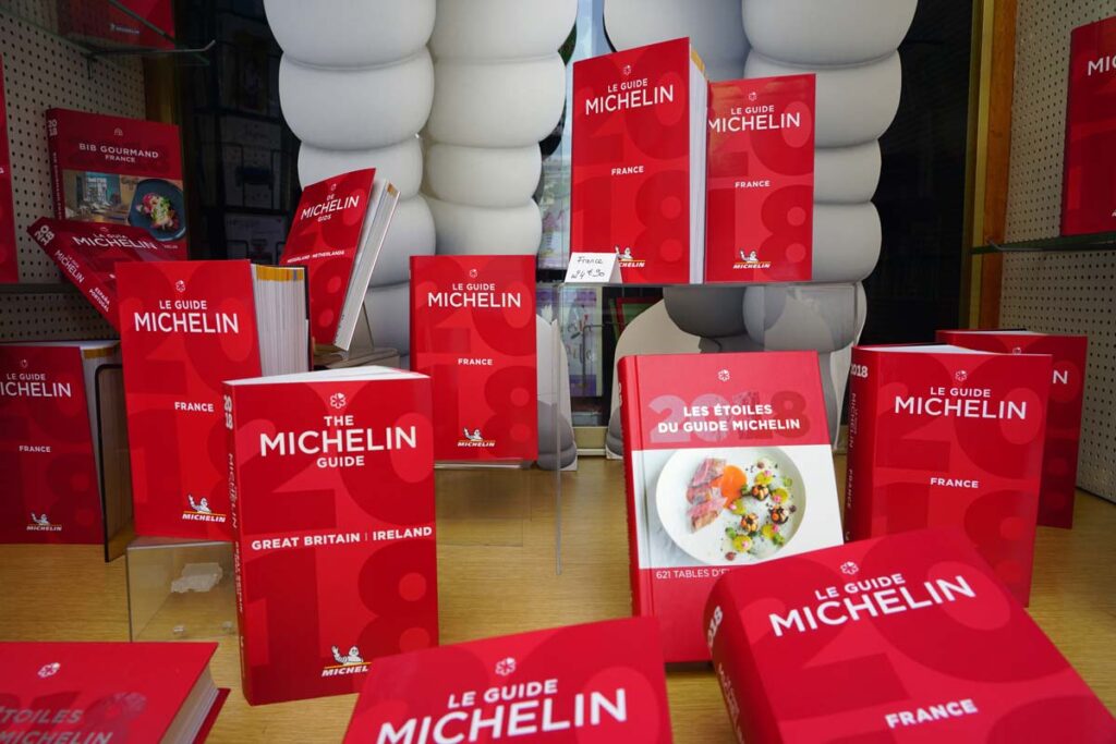 Various Michelin guidebooks on display for sale, representing the Michelin Guide hotels rating.