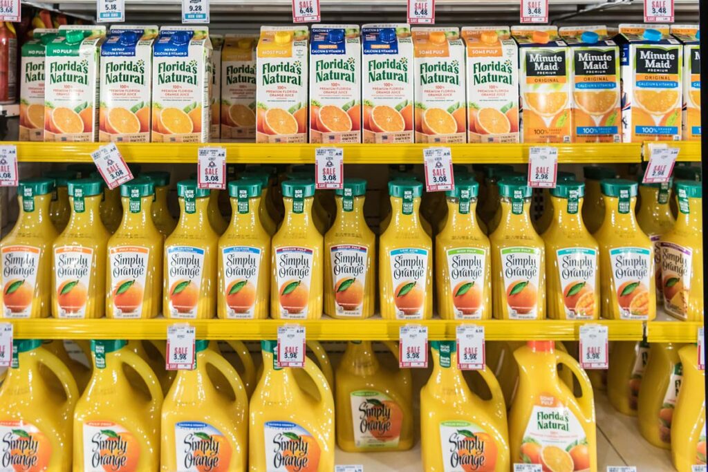 Various juice products on a grocery store shelf, representing recent false advertising class action lawsuits over "100% juice" claims on products.