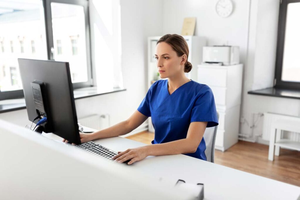 A nurse using a computer, representing the Teen Challenge Training Center data breach settlement.