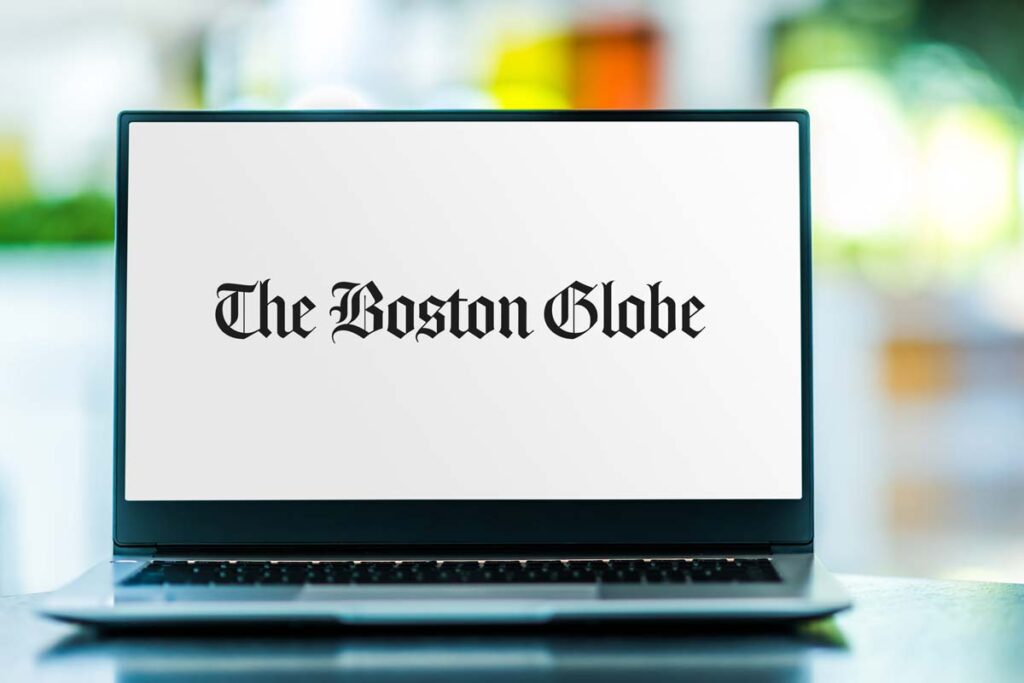 Boston Globe logo displayed on a laptop screen, representing the Boston Globe settlement.