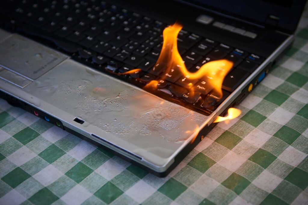 Close up of a laptop on fire, representing the HP laptop battery fire lawsuit.