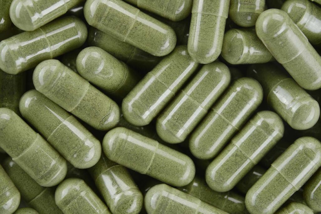 Close up of green capsules, representing the Balance of Nature class action lawsuit settlement.