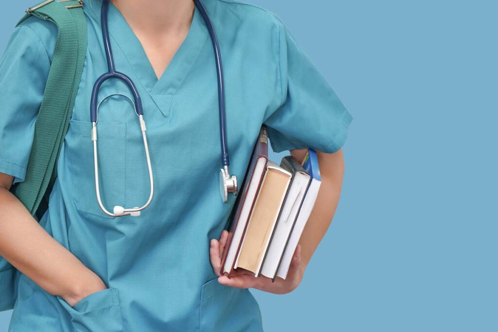 Close up of a female nursing student holding books, representing the nursing school lawsuit.
