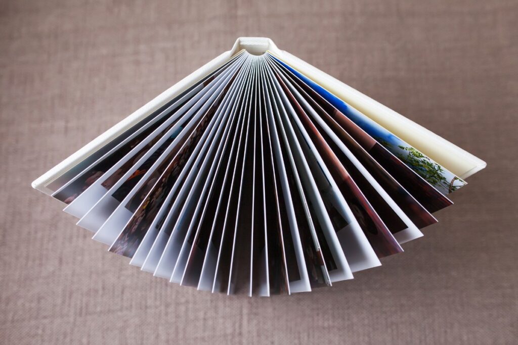 A photo book sits on its end with the pages fanned, representing the Shutterfly class action settlement.