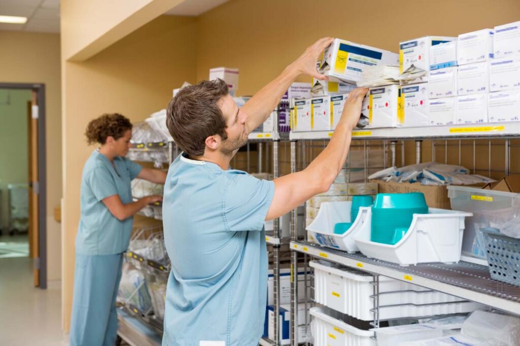 Medical professionals restocking a med supply room, representing the irrigation product recall.