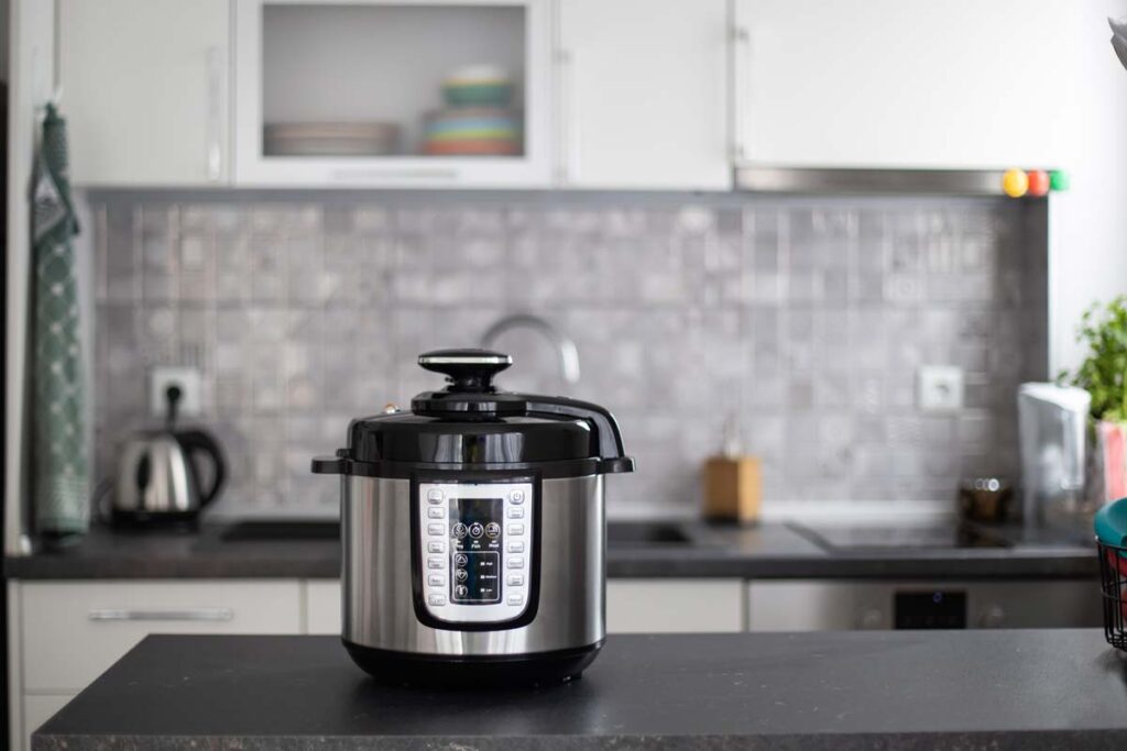 A pressure cooker on a countertop in a kitchen, representing the Best Buy Insignia pressure cooker recall.