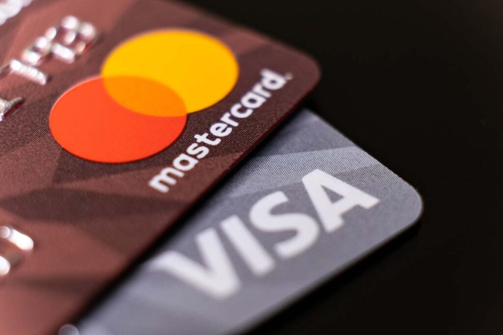 Close up of Mastercard and Visa logo on cards, representing the Visa and Mastercard fees settlement.