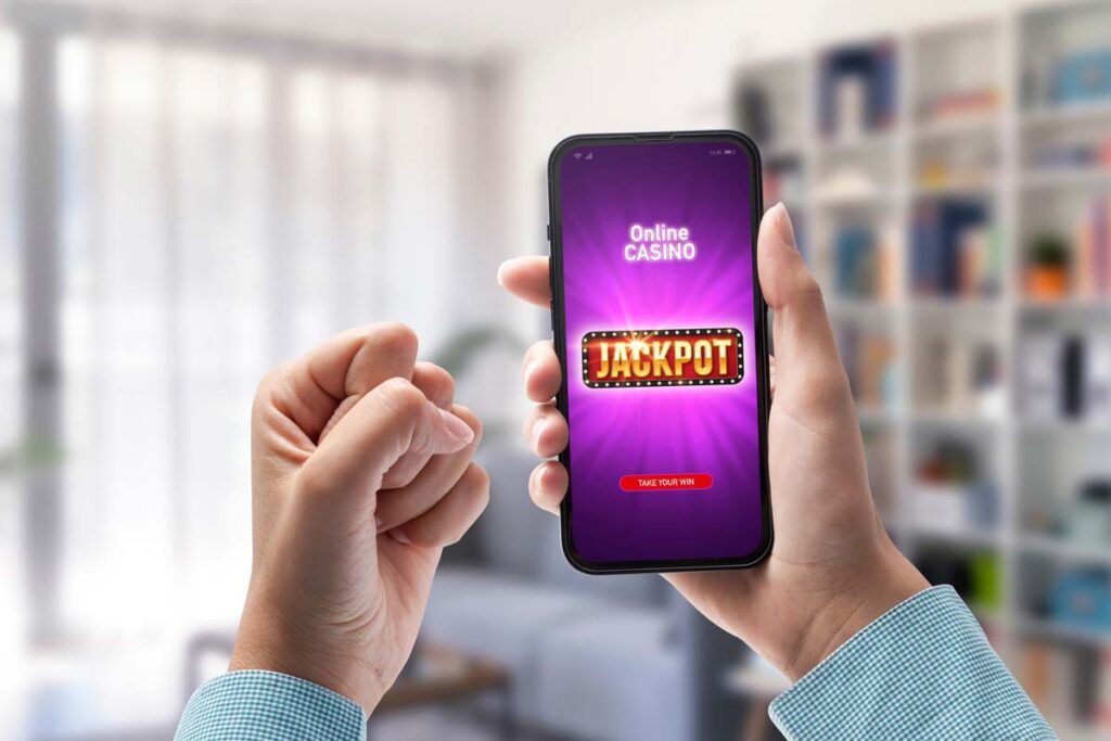 A person plays an online casino app on a smartphone, representing the Woopla Funzpoints virtual currency class action lawsuit settlement.
