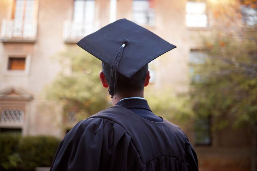 Back view of a male student wearing a graduation cap, representing first-generation law students.