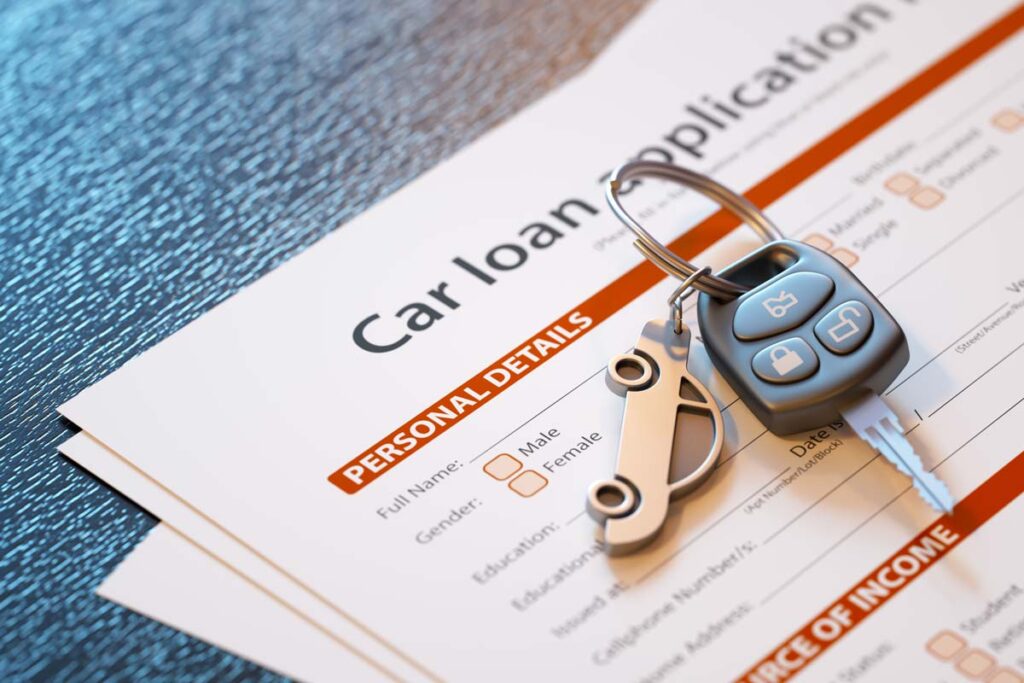 Car keys on top of a car loan application, representing the Toyota Motor Credit settlement.
