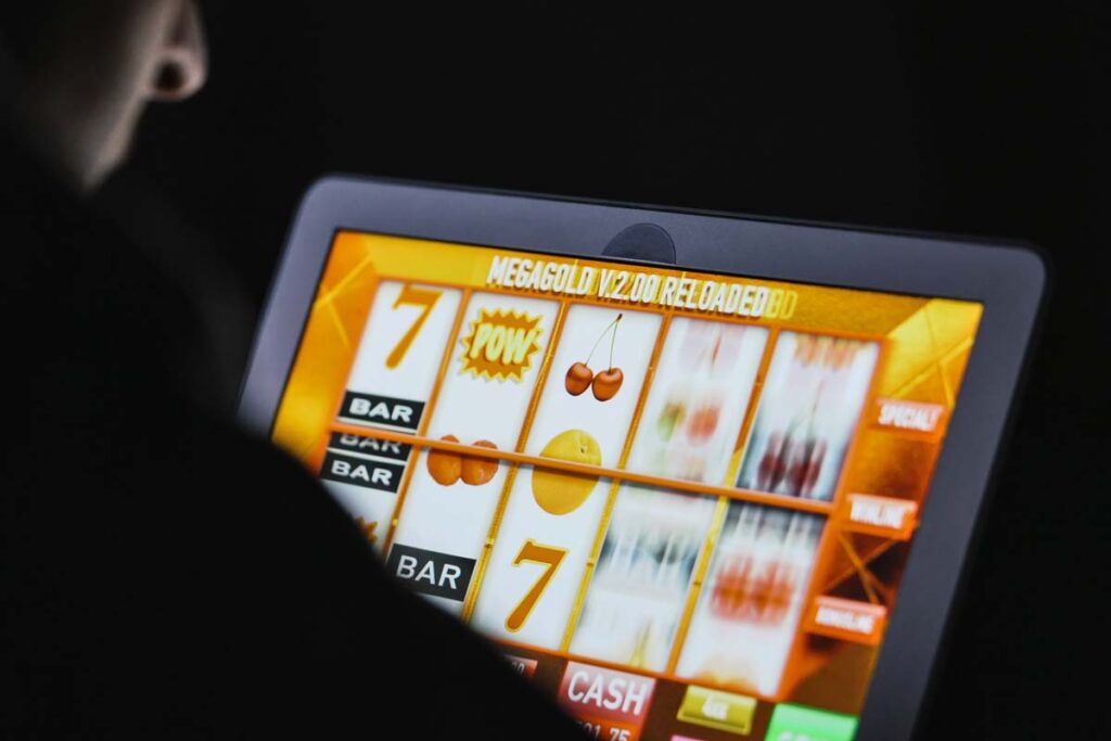 A man playing a casino game on his iPad, representing the Pulsz class action lawsuit settlement.