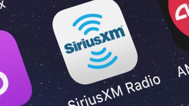 Close up of Sirius XM app icon displayed on a smartphone screen, representing the SiriusXM subscription cancellation lawsuit.