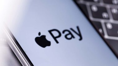Close up of Apple Pay logo displayed on a smartphone screen, representing the Apple, Mastercard and Visa lawsuit.