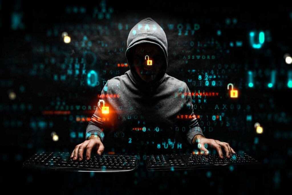 A hooded hacker using a keyboard, representing the Progress Software data breach lawsuits.