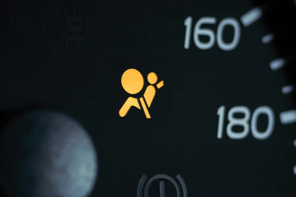 Illuminated airbag symbol on a car dashboard, representing the Toyota and Lexus recall.
