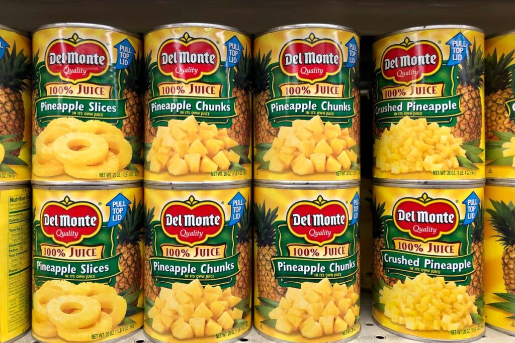Close up of Del Monte canned fruit on a grocery store shelf, representing the Del Monte class action.