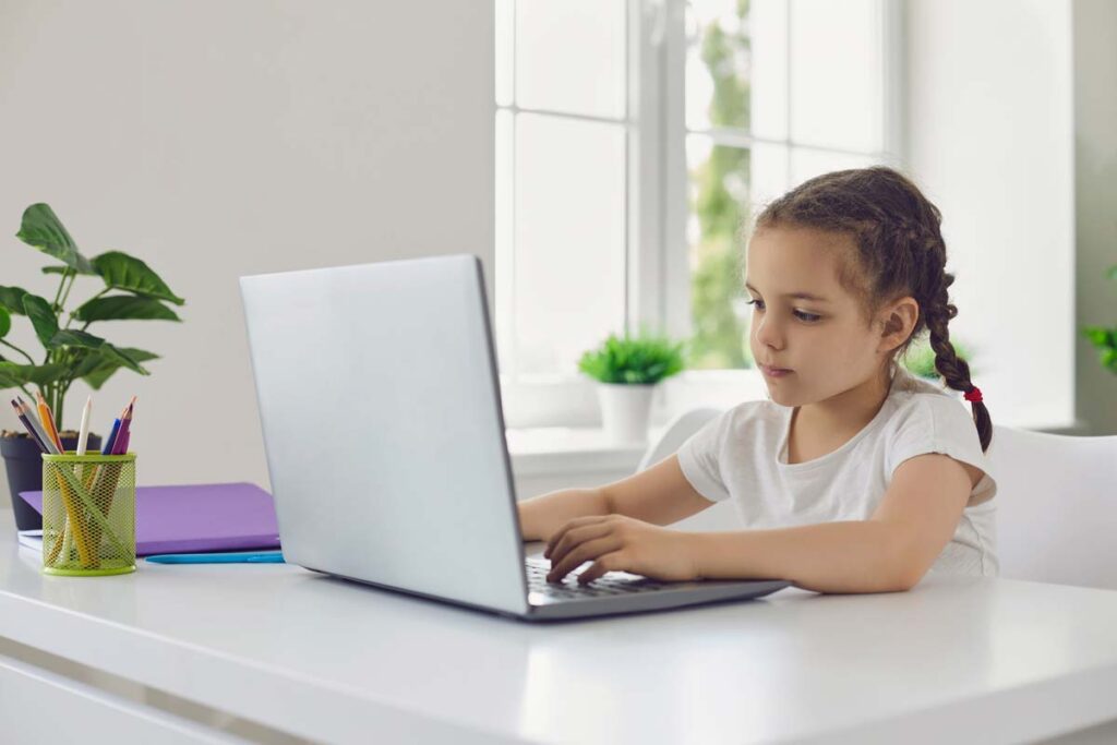 A young girl using a laptop, representing the FTC proposing strengthening the Children’s Online Privacy Protection Rule.
