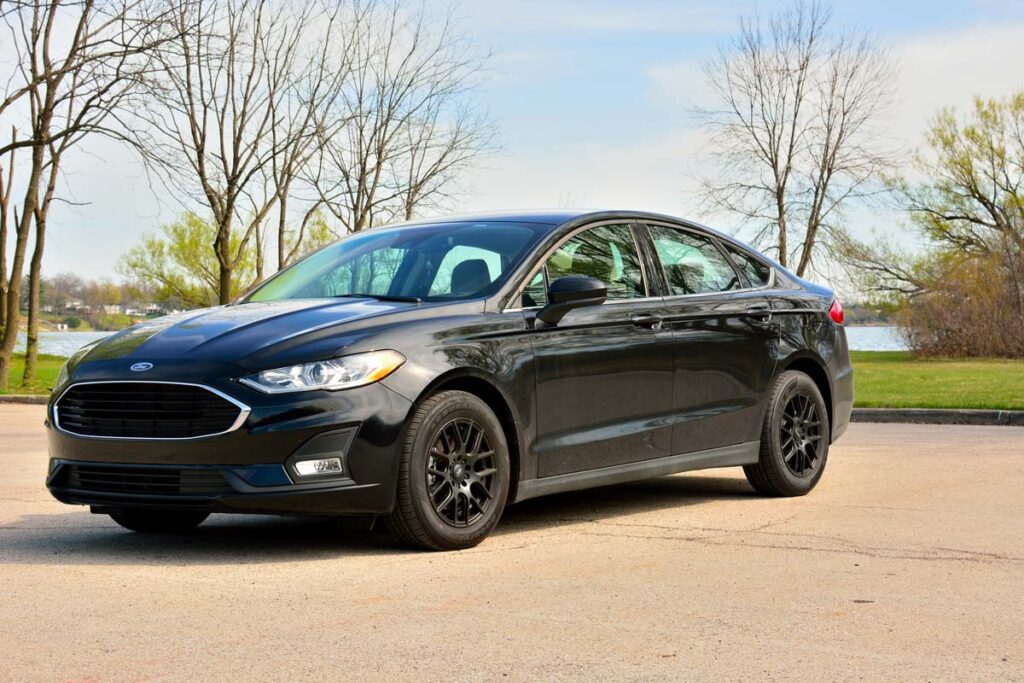 A black 2020 Ford Fusion, representing the Ford recall over a door-opening risk.