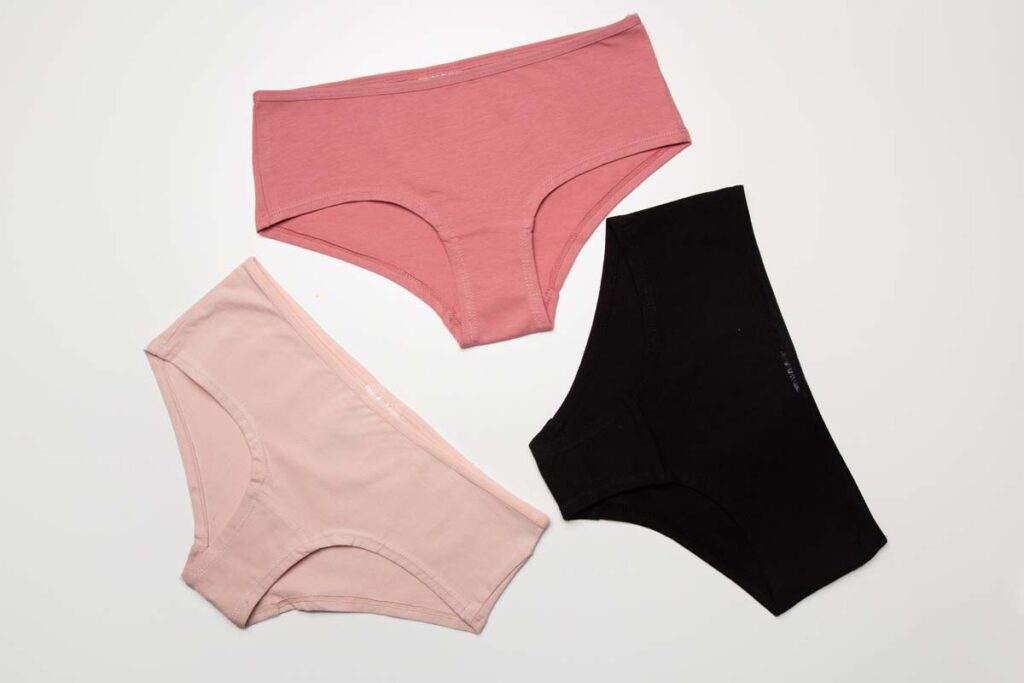 Three pairs of women's underwear are shown against a white background, representing the Knix class action lawsuit settlement.