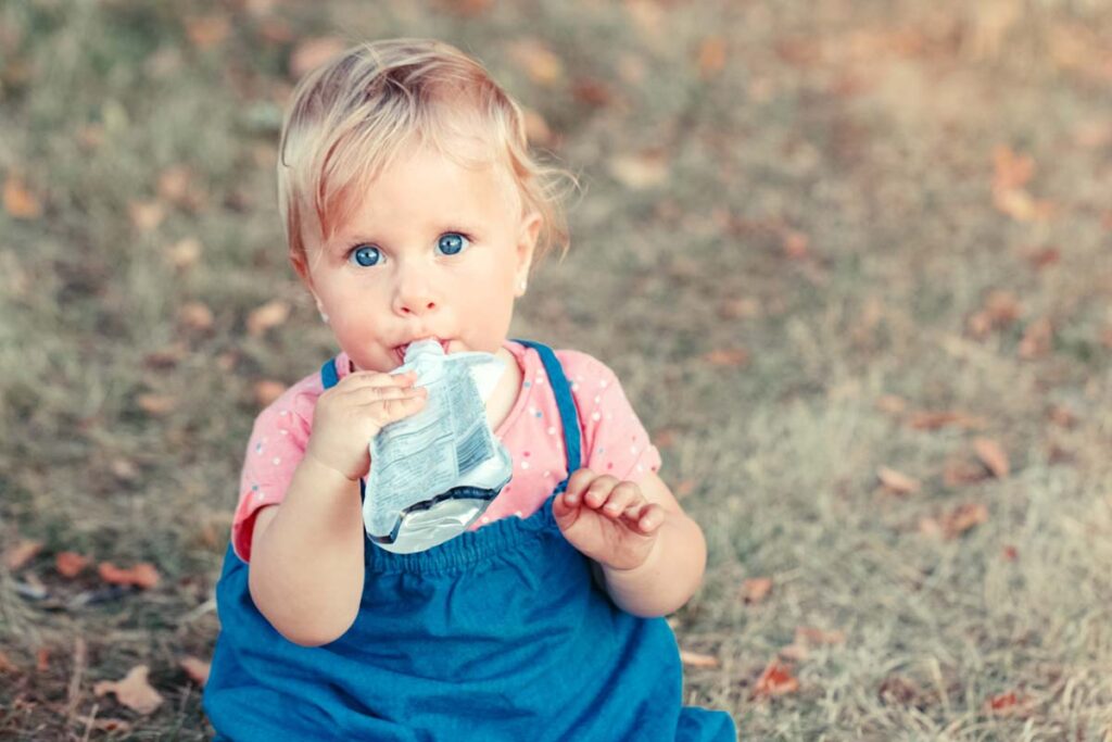 A young child eating from a puree pouch, representing the Wanabana lead class action lawsuit.