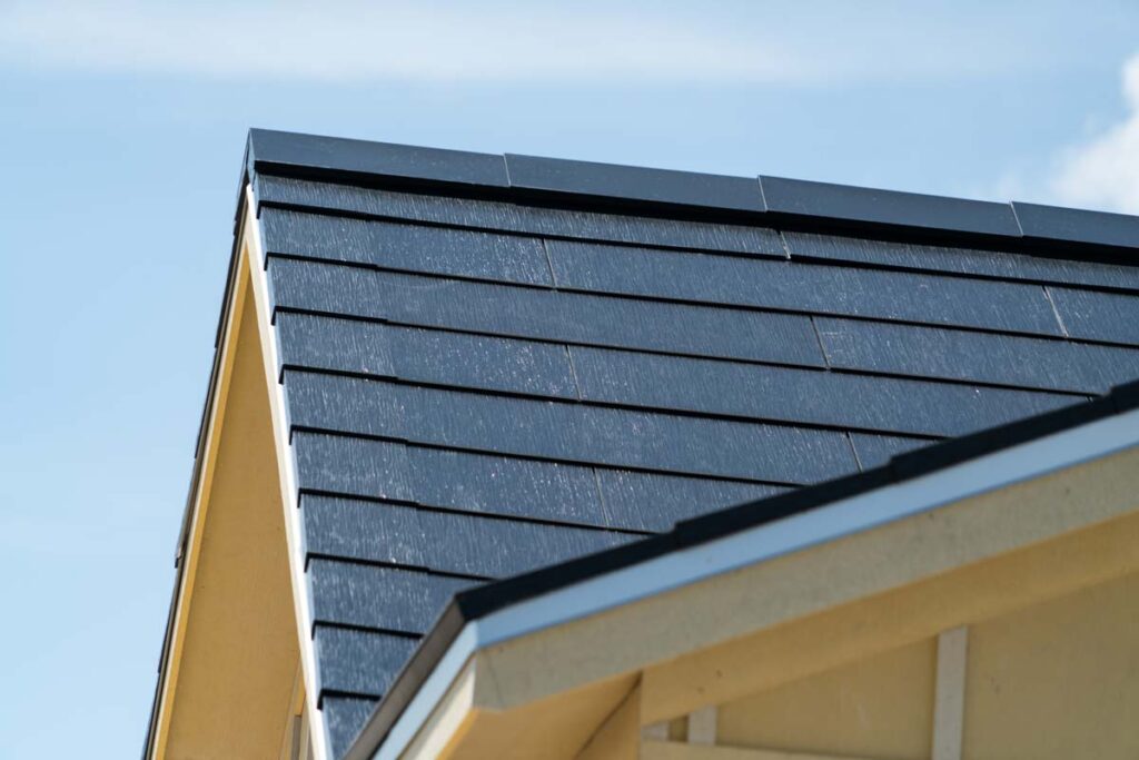 Close up of Tesla solar tiles on a rooftop, representing the Tesla solar roof settlement.