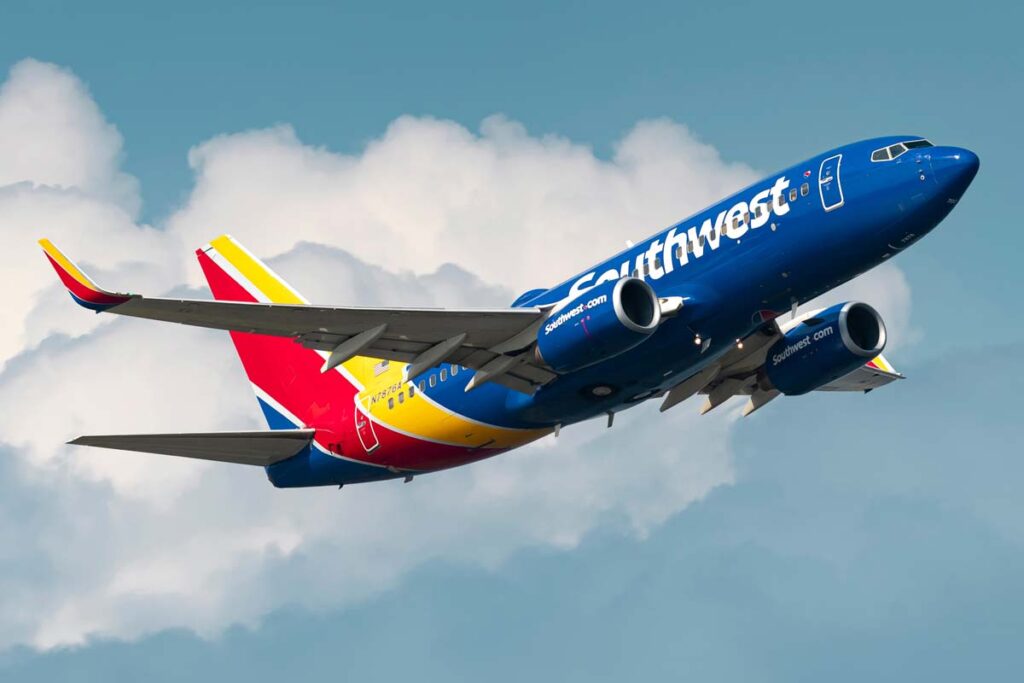 A Southwest plane in flight, representing the Southwest flight cancellations fine.