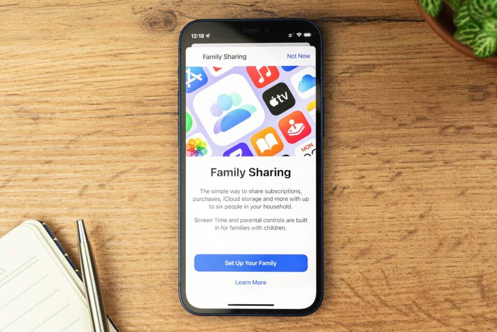 Apple family sharing page displayed on a smartphone screen, representing the Apple Family Sharing subscription class action lawsuit settlement.