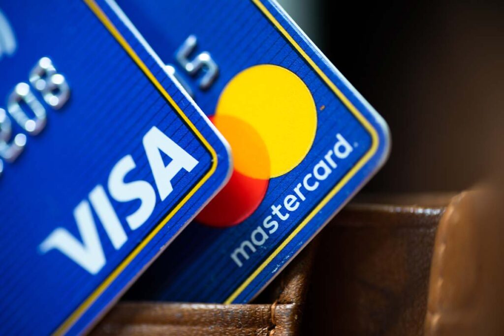 Close up of Visa and Mastercard logo on cards, representing the scam Visa Mastercard settlement website.