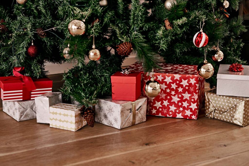 Wrapped presents under a Christmass tree, representing product safety recalls.