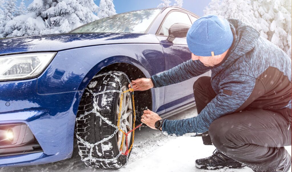 Putting winter chains on car.